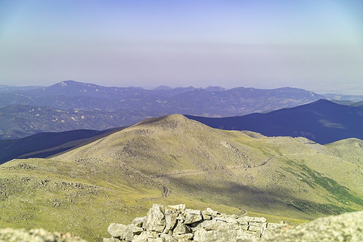 Winding alpine road up Mount Evans with mountain goats near the summit