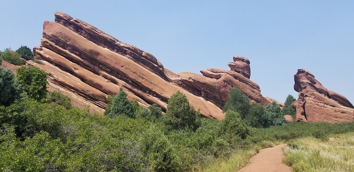Trail winding between towering red sandstone formations at Red Rocks Park