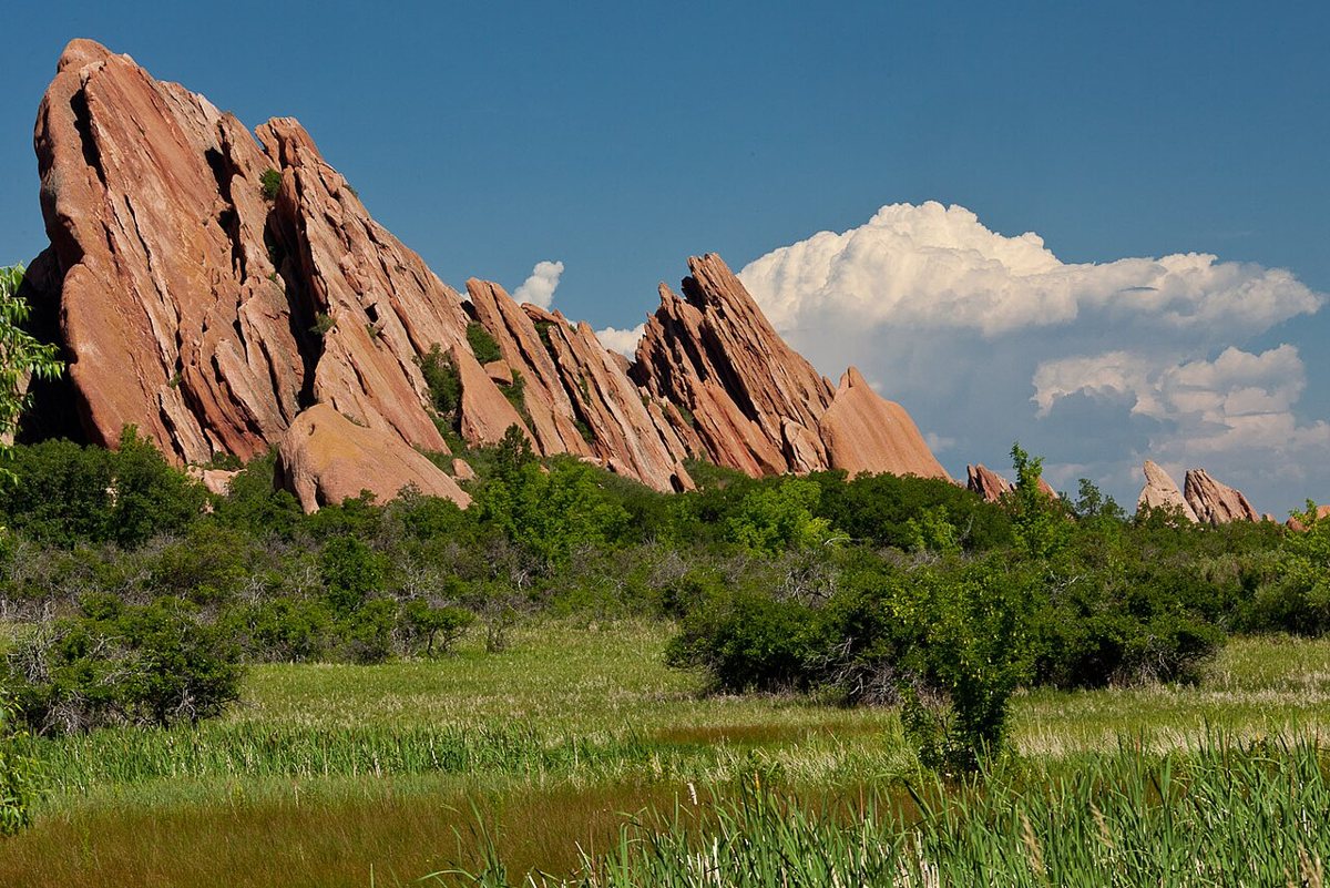 Red sandstone rock fins rising above a hiking trail in Roxborough State Park