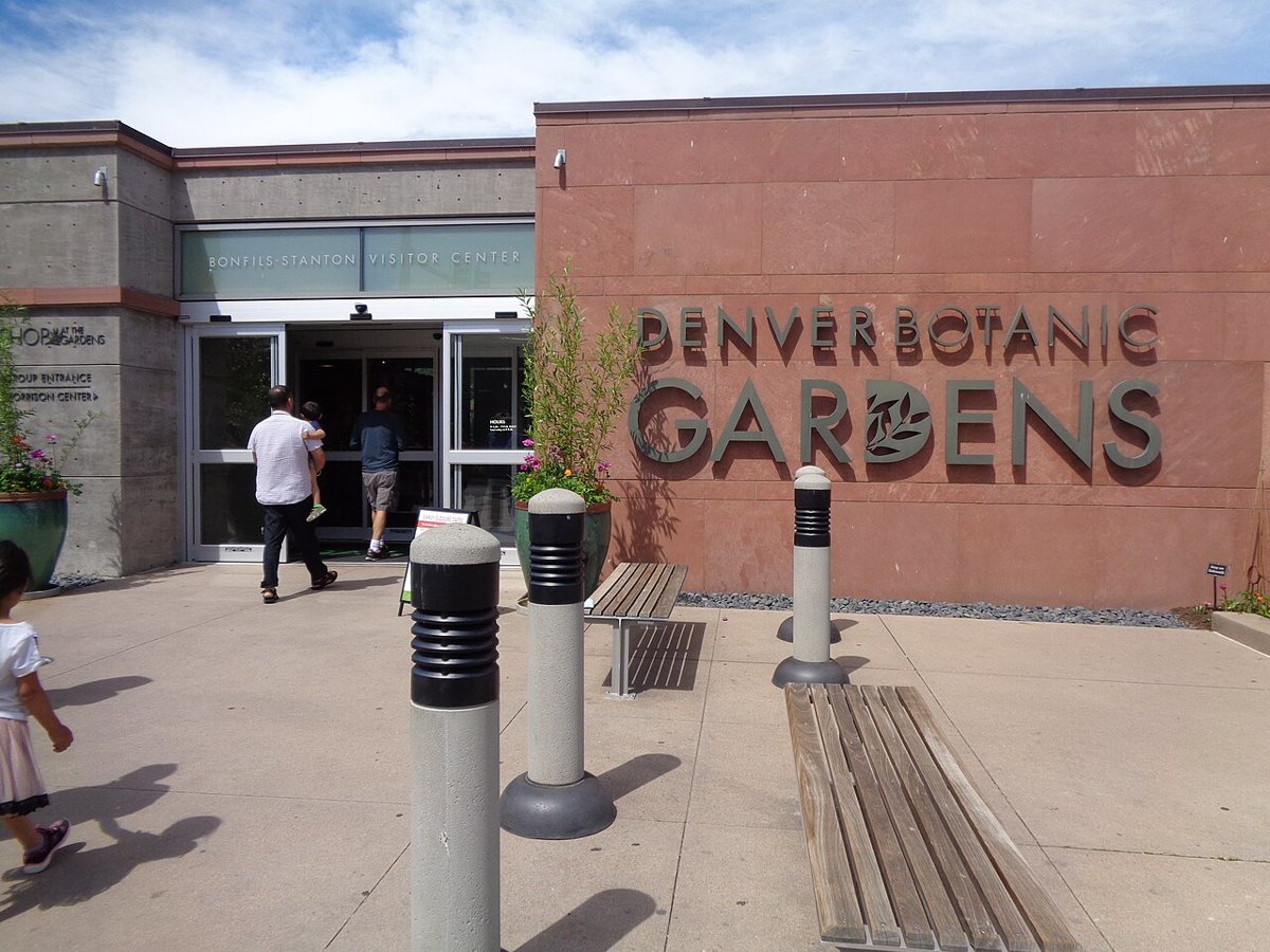 York Street entrance garden at Denver Botanic Gardens with flowering perennials and glass conservatory building
