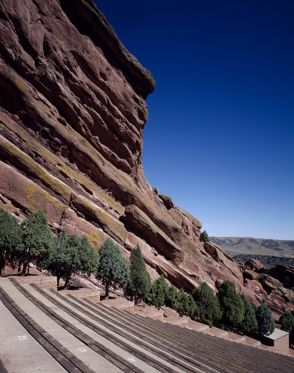 Sandstone rock formations of Red Rocks Amphitheatre with the Denver plains visible in the distance