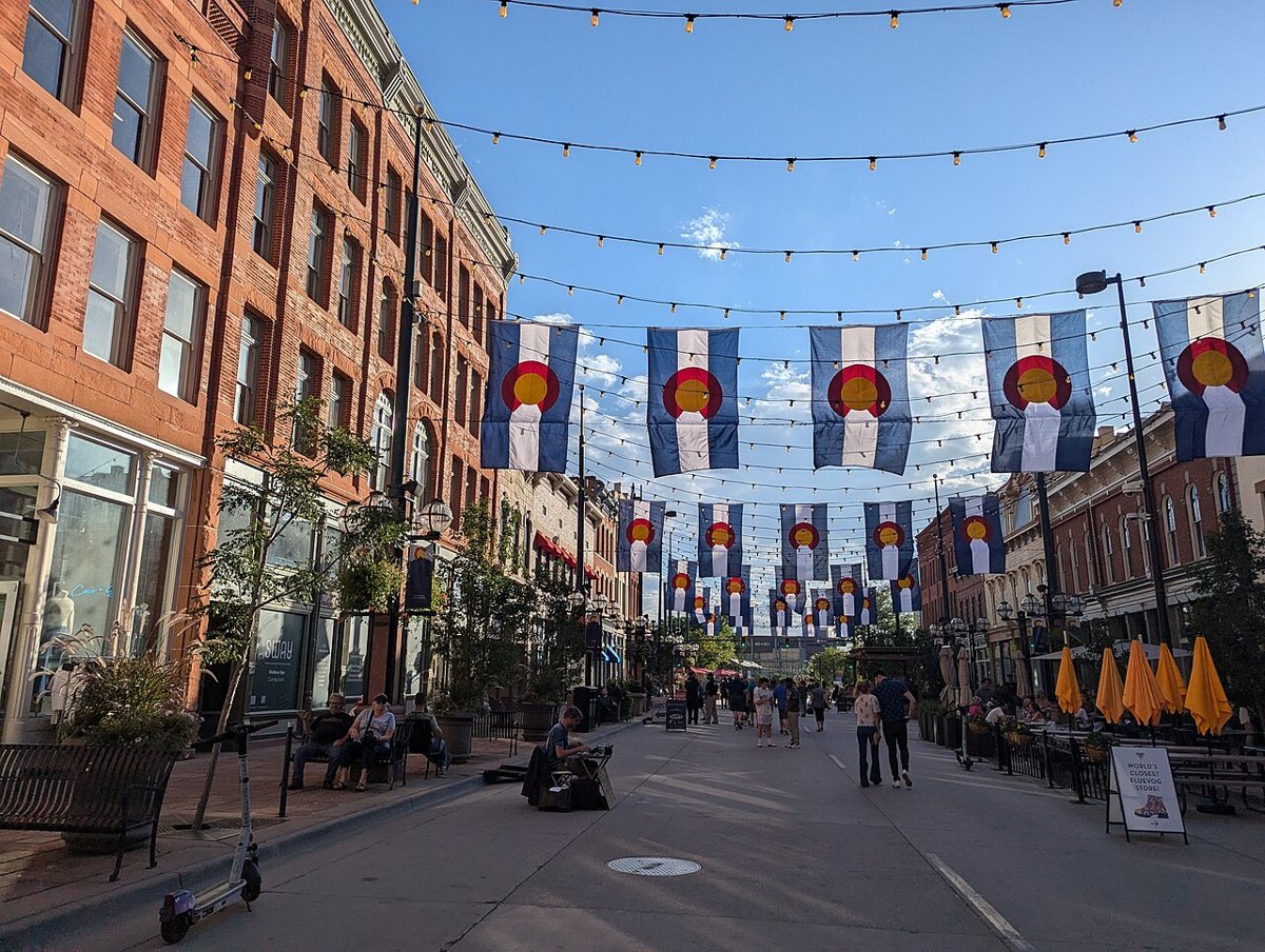 String lights and Victorian storefronts along Larimer Square in downtown Denver at dusk