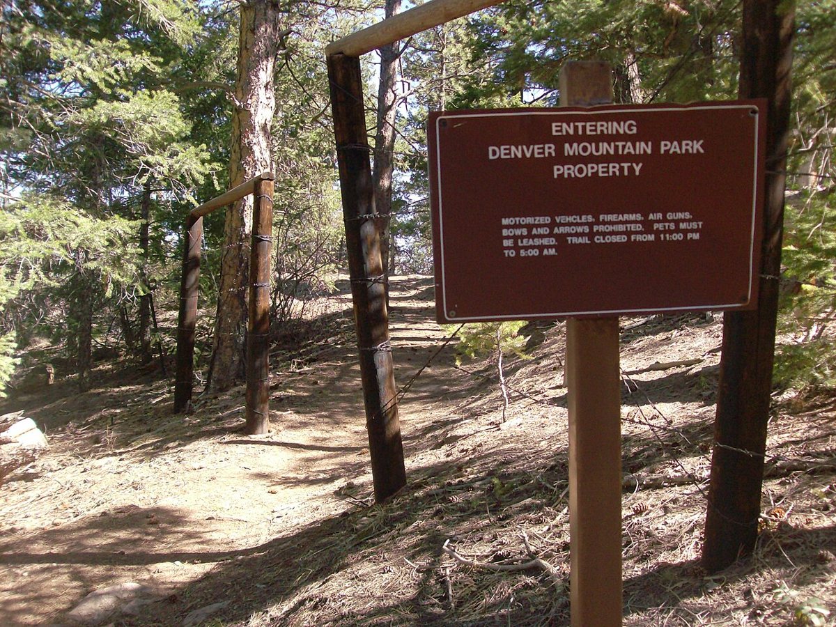 hikers on a trail with mountain views at Mount Falcon Park