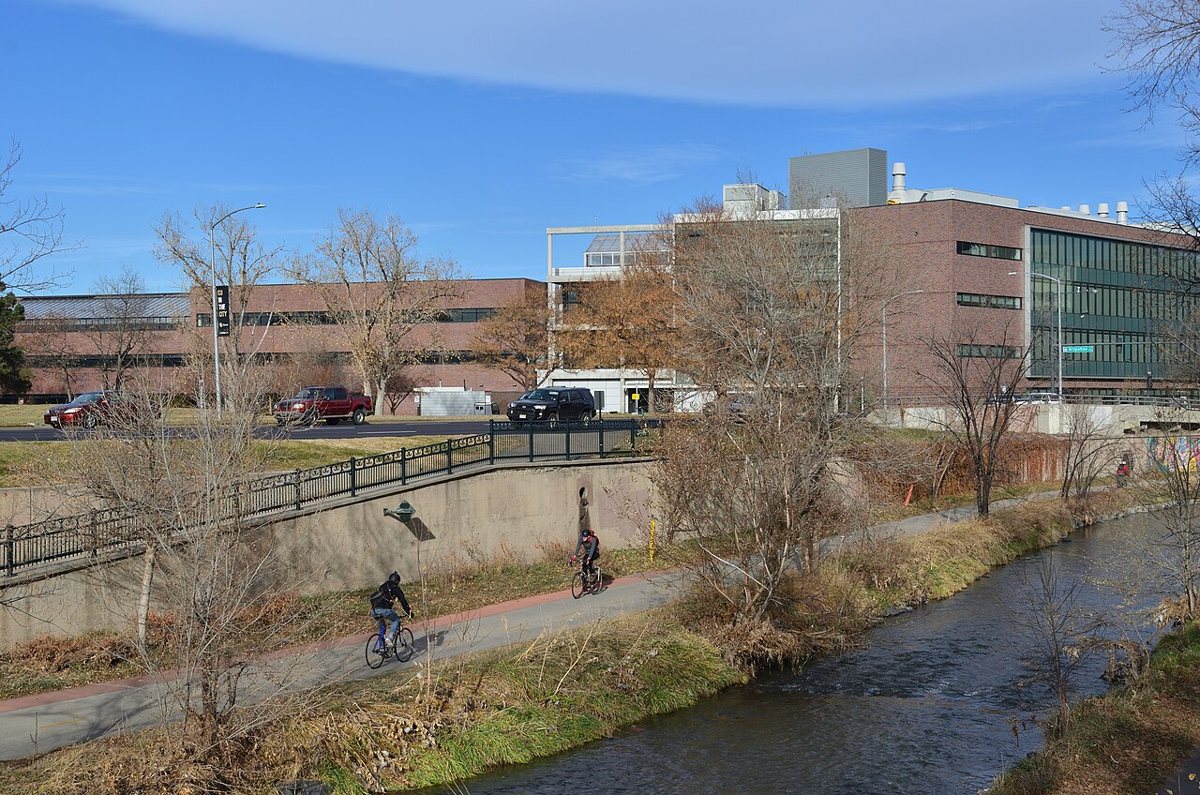 Cyclists riding along the Cherry Creek Trail in downtown Denver