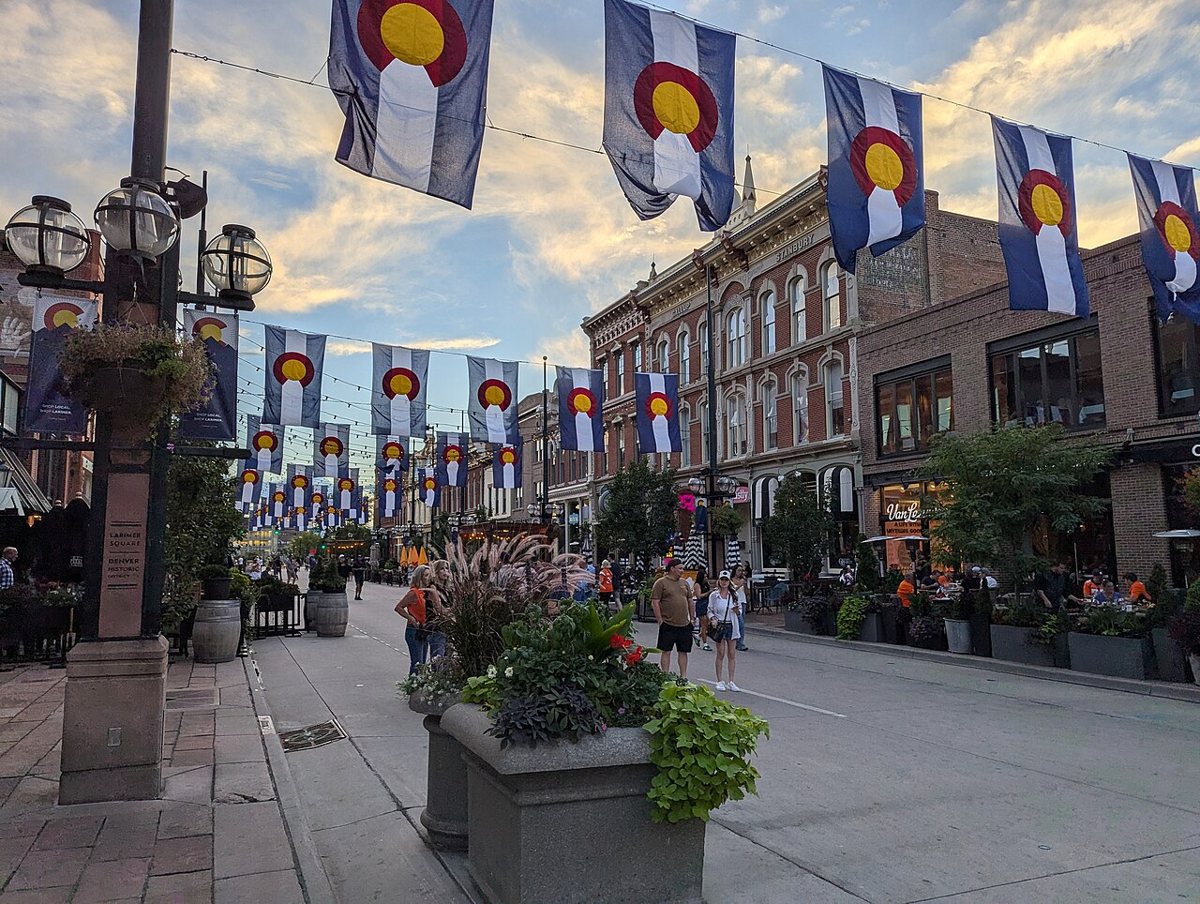 the historic brick facades and string lights of Larimer Square at dusk